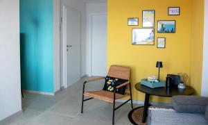 a living room with a table and a chair at holiday by the sea in Marusici 