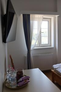 a table with a plate of food and a window at La Veneziana Guesthouse in Aschach an der Donau