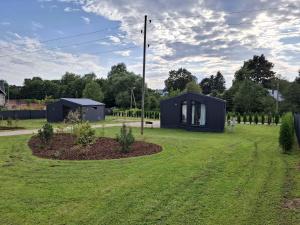 a tiny house in the middle of a yard at Sun coast house in Saulkrasti