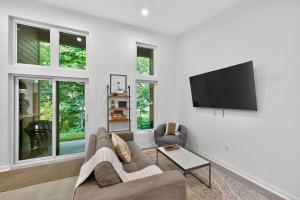 a living room with a couch and a flat screen tv at 500 House - Unit A townhouse in Thiensville +29 photos