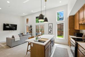 an open kitchen and living room with a couch at 500 House - Unit C townhouse in Thiensville