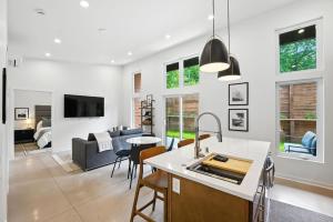 a kitchen and living room with white walls at 500 House - Unit D townhouse in Thiensville +32 photos