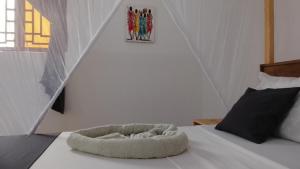 a bed with a dog bed on top of it at Maku House in Makunduchi +19 photos