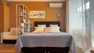 a bedroom with a bed and a chair at Emerald Breeze Studio in Hotel SPA Resort Emerald in Ravda +7 photos