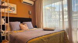 a bedroom with a bed with a large window at Emerald Breeze Studio in Hotel SPA Resort Emerald in Ravda