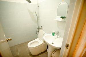 a bathroom with a toilet and a sink and a mirror at Loboc Nature View House in Loboc +47 photos