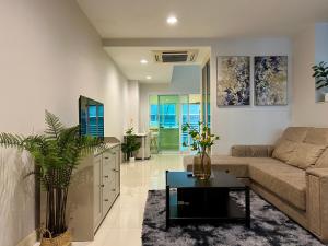 a living room with a couch and a table at Entire 3BR Townhome in Sukhumvit, shared Pool, near BTS&MRT Asok in Bangkok