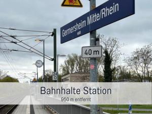 two blue street signs on a pole with a street at City-Apartment Germersheim in Germersheim