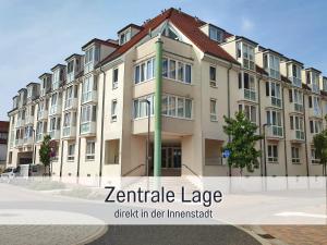 a large building with the words variable large check in der investment at City-Apartment Germersheim in Germersheim