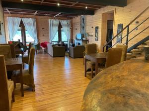 a room with tables and chairs and a living room at Omaya Hills in Nuwara Eliya