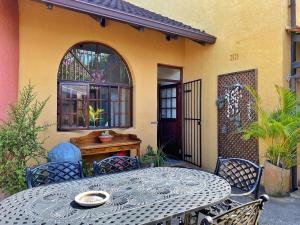 a table and chairs sitting outside of a house at Casa Miramare - Marina Beach in Southbroom