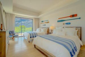 a hotel room with two beds and a window at Villa Libertad, amazing pool ,modern design in El Infiernito +63 photos