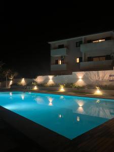 a swimming pool in front of a building at night at Mare Palau Sardegna in Palau