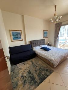 a bedroom with a bed and a couch at Marina Diamond in Dubai +18 photos