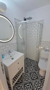 a bathroom with a sink and a toilet and a mirror at Ultracentral Mangalia seaside exclusive in Mangalia +18 photos