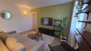 a living room with a couch and a tv at Ultracentral Mangalia seaside exclusive in Mangalia