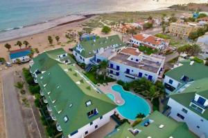 an aerial view of a resort and the beach at Leme Bedje - By Bobbywashere in Santa Maria