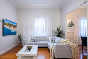 a living room with a couch and a table at Central Haven Milton 4BR Sleeps 10 in Brisbane