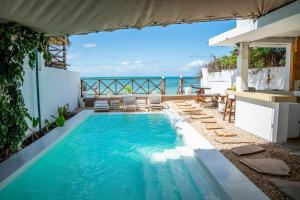 an infinity pool with the ocean in the background at ZAN Sun Beach in Makunduchi