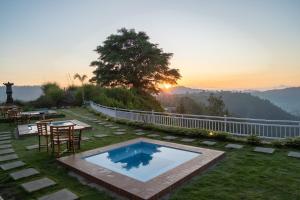 a backyard with a pool and a table and chairs at pohon cinta glamping in Baturaja +9 photos