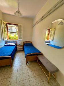 a bedroom with two beds and a mirror at La casa di Lilly in Villaggio Azzurro