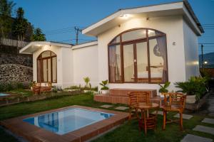 a house with a small pool in the yard at pohon cinta glamping in Baturaja