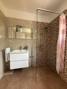 a bathroom with a sink and a shower at NEW Apartment Ema II in Vrh +24 photos
