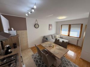 a living room with a table and a couch at Kuća za odmor Saturnus in Karanac