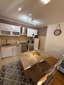a kitchen and dining room with a wooden table and chairs at Kuća za odmor Saturnus in Karanac +6 photos