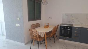 a kitchen with a table and chairs in a kitchen at חלום מול נוף הכנרת in Tiberias