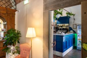 a kitchen with blue cabinets and a counter at Quattro Gigli Hotel in Montopoli in Val dʼArno