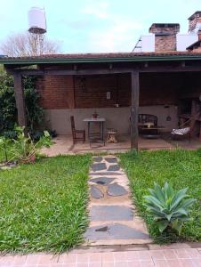 a patio with a stone path in the grass at Casa costa oeste in Posadas