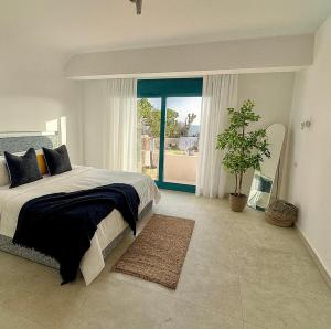 a bedroom with a large bed and a potted plant at Fask Villa Zakynthos, Infinity Views & Serenity by Villa Mana Gers in Akrotiri