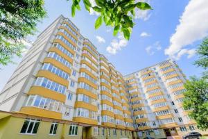 a large apartment building with yellow and white at Fine Sleep & Fly in Chişinău