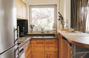 a kitchen with a sink and a window at Grünten-Blick Apartment in Sonthofen