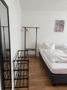 a living room with a bed and a mirror at Apartment Plini in Montabaur