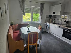 a kitchen and living room with a table and a couch at Ella's Wolke Appartements - EW6 in Zweibrücken