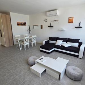 a living room with a couch and a table at Harmónia apartman in Zánka