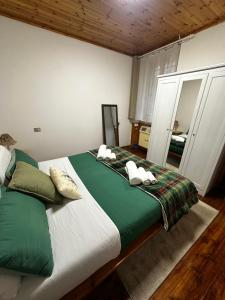 a bedroom with a large bed and a mirror at Favoloso alloggio a Branzi in Branzi