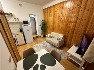 a living room with a table and a couch at Favoloso alloggio a Branzi in Branzi
