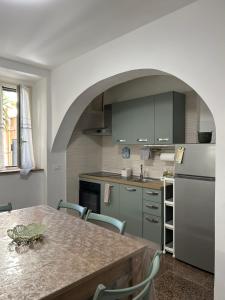 a kitchen with a table with chairs and a refrigerator at Casa Rosa - Vasto in Vasto
