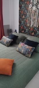 a bed with three pillows on top of it at cal'Nathalie in San Juan de los Terreros +62 photos