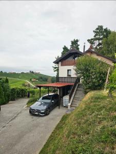 a car parked in the driveway of a house at Hilltop vineyard house in Ivanjkovci