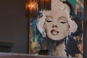 a painting of a woman with her tongue out at Hotel Angeleno in Los Angeles