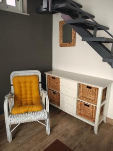 a chair with an orange pillow sitting next to a desk at Sospiro dell'Etna in Zafferana Etnea +46 photos