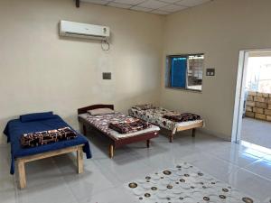a room with two beds and a air conditioner at Gauri Villa in Dwarka