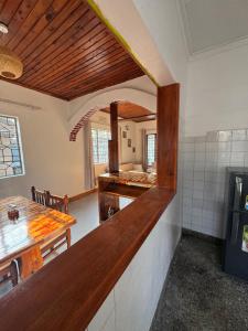 a kitchen with a counter and a table in a room at Arusha backpackers homes in Arusha