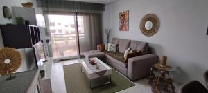 a living room with a couch and a table at cal'Nathalie in San Juan de los Terreros
