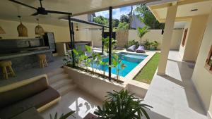 a living room with a swimming pool in a house at HomeVillas in Kuta Lombok