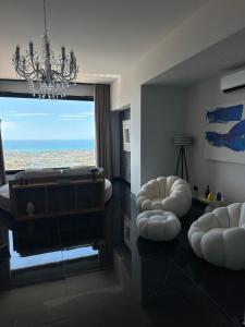 a living room with a piano and a chandelier at Vista Templi Luxury Suite in Agrigento